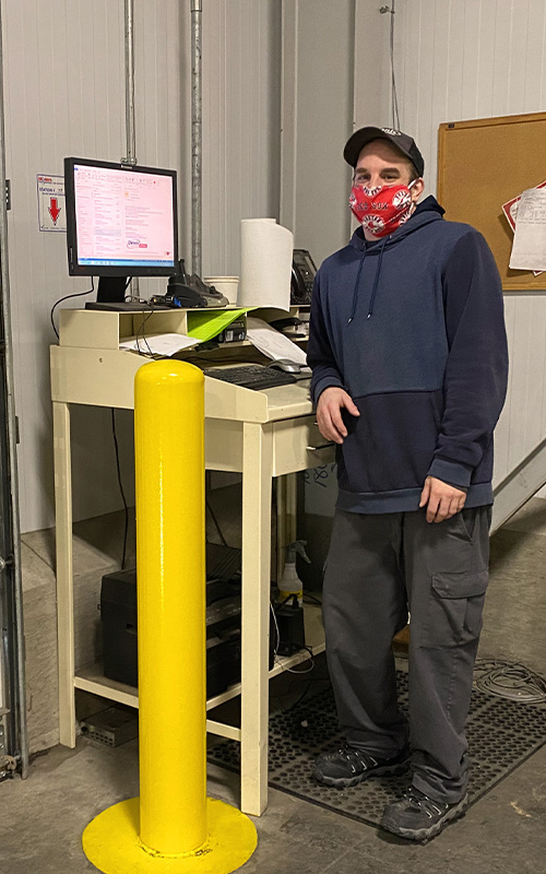 man standing next to computer